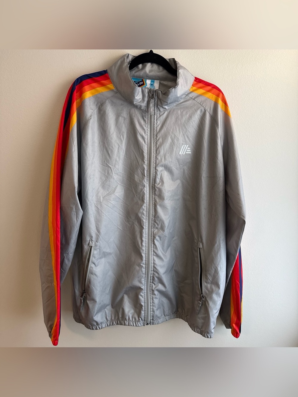 Lightweight gray Aldi zip-up windbreaker featuring colorful retro rainbow stripe